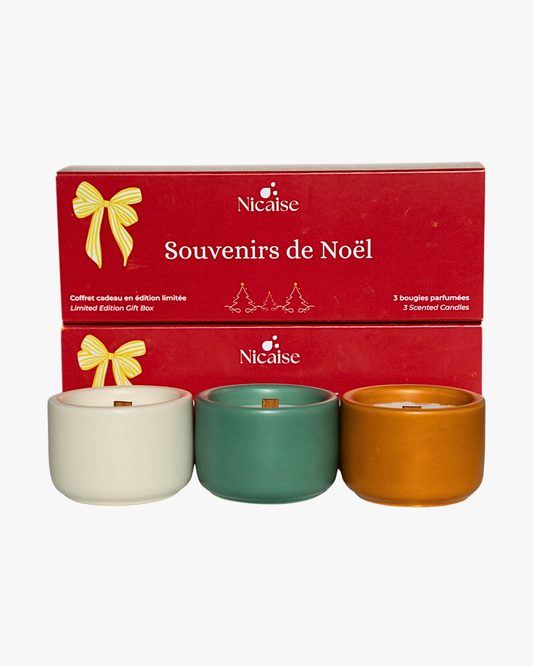 Coffret cadeau Nicaise « Souvenirs de Noël » avec 3 mini bougies parfumées en pots (blanc, vert, marron) et mèches en bois, sur fond blanc.